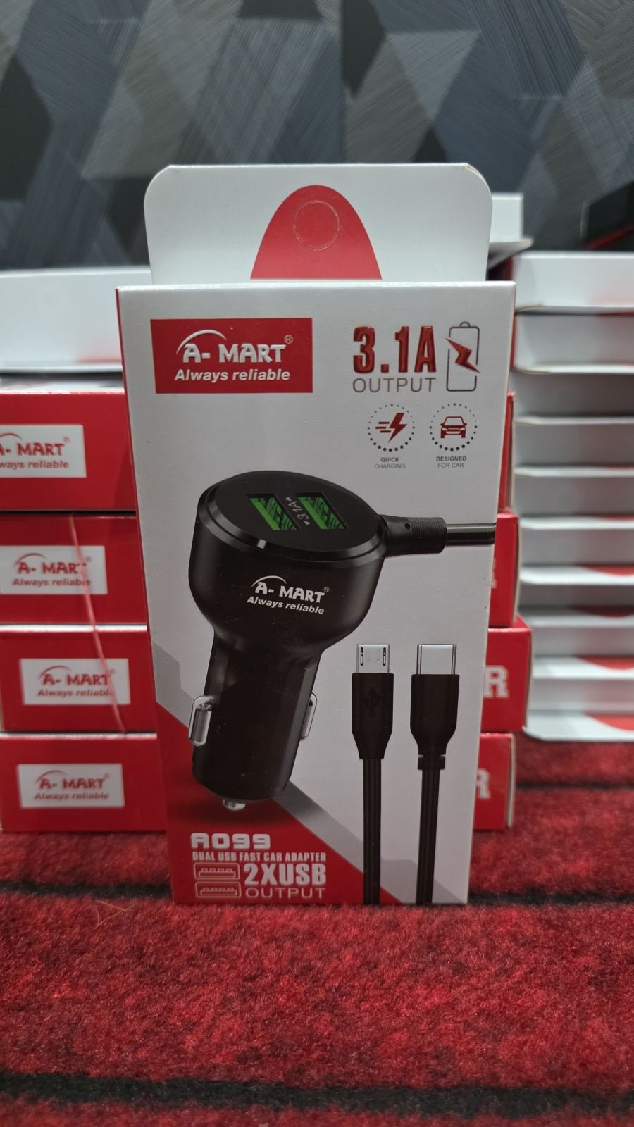 A-Mart A099 Dual USB Fast Car Adapter, a black dual-port car charger with a 3.1A total output that includes charging cables