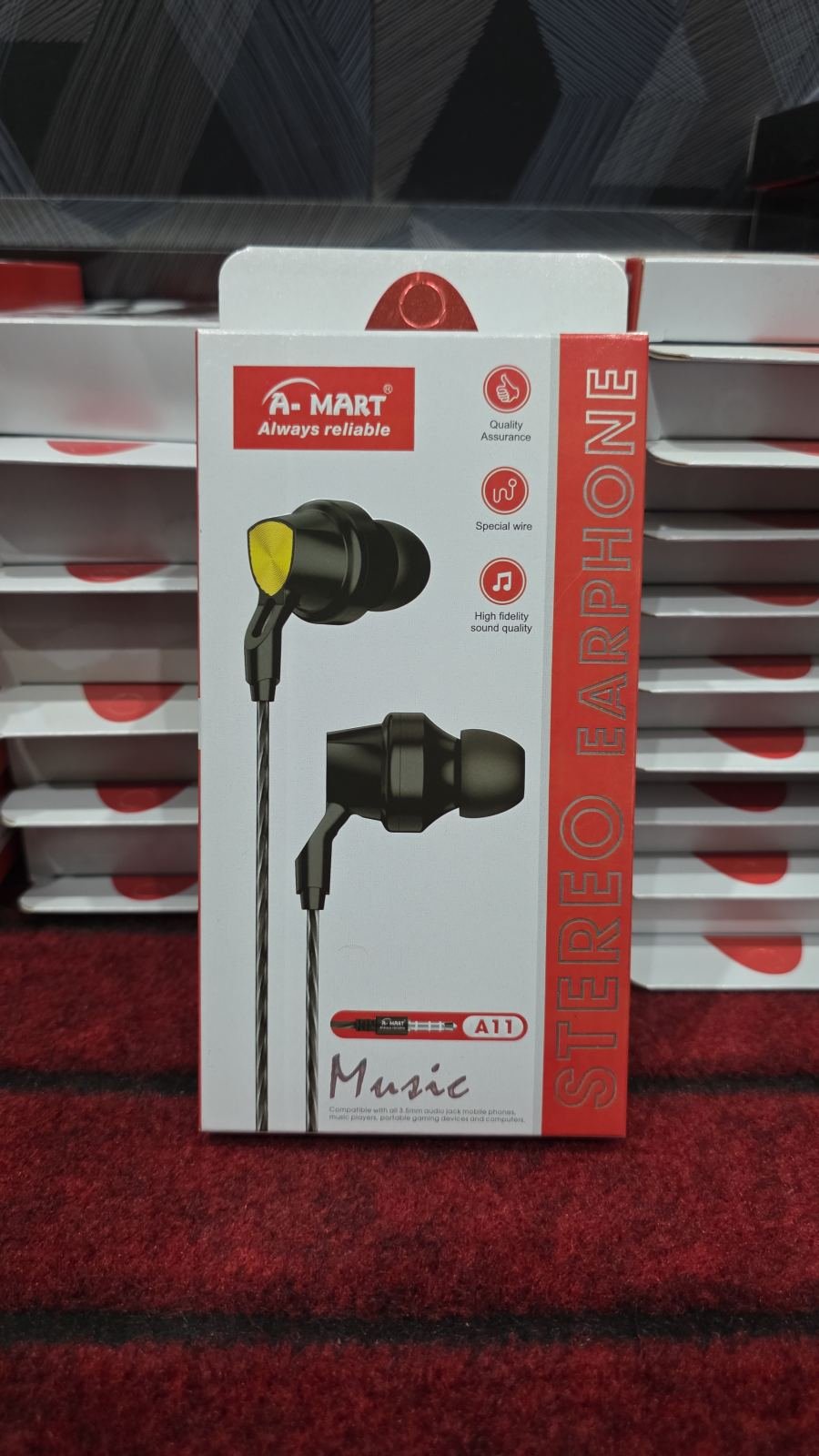A-Mart A11 Stereo Earphone featuring black in-ear design with yellow-accented earbuds and a 3.5mm audio jack